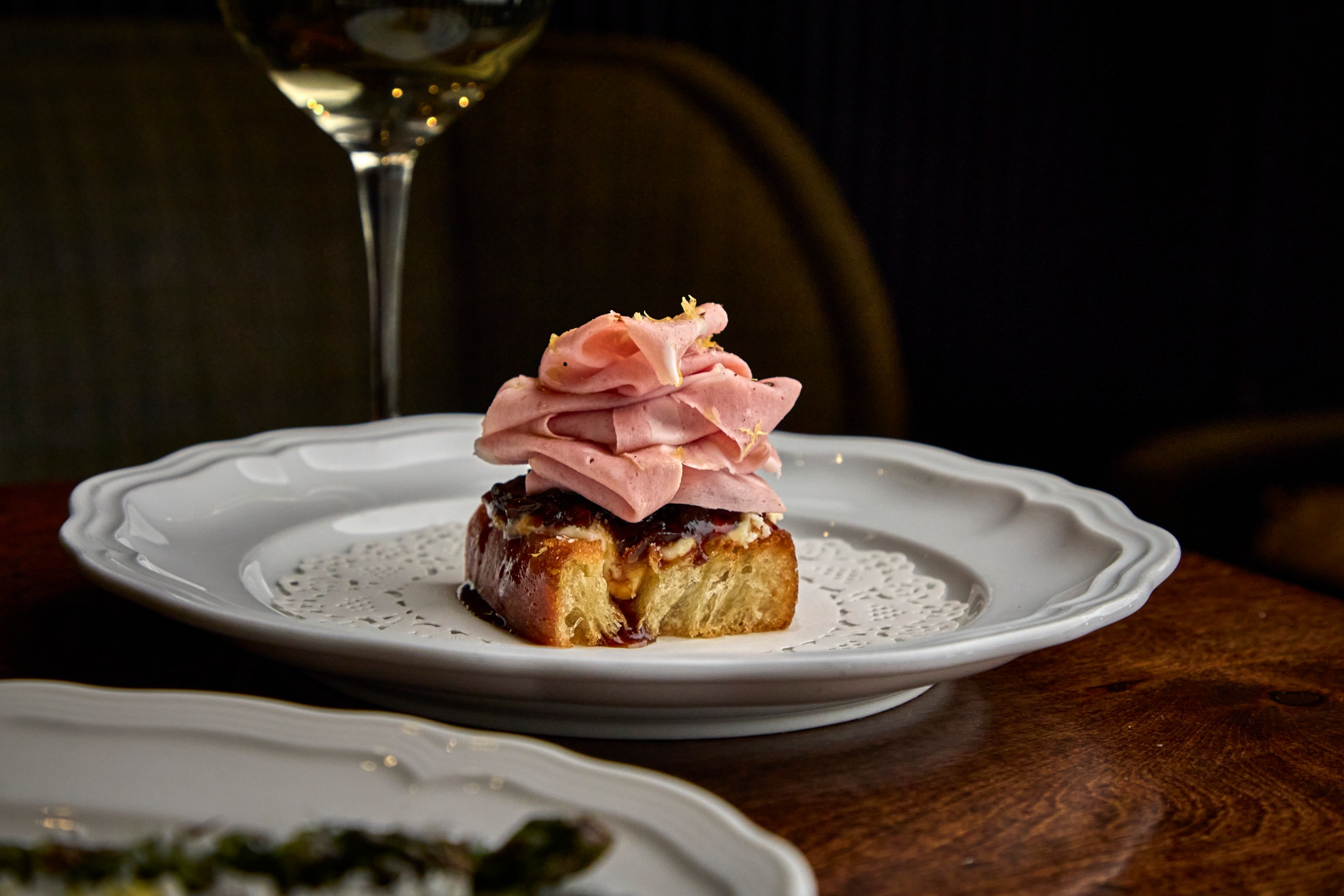 Mortadella toast appetizer topped with sliced mortadella at Alla Vita Nashville