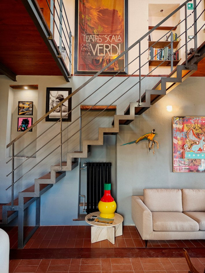 Interior library and lounge space inside Club Carpeneto featuring artwork and restored architectural details.
