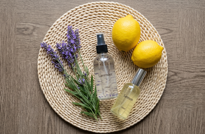 Essential Oil Bug Repellent with lemons and herbs on a table