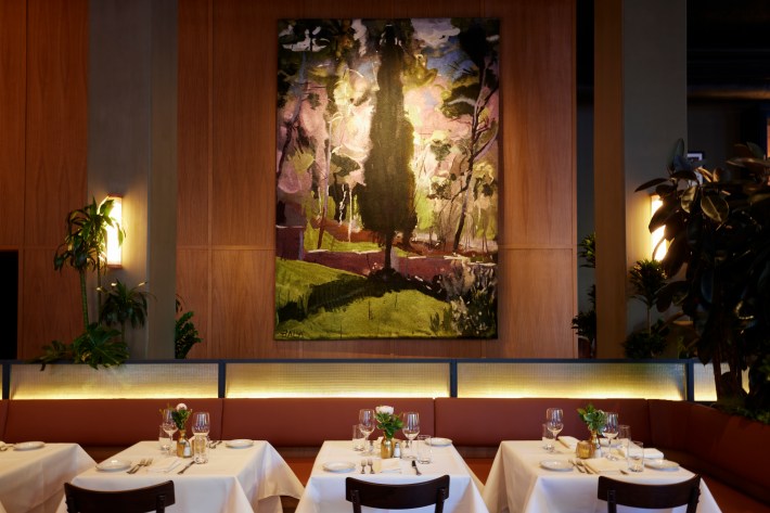 The dining room at Felice Flatiron pairs warm design with views of Madison Square Park.