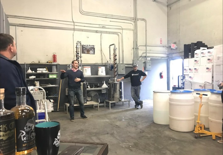 Anthony Scalabrino speaking inside a craft distillery during Oak City Amaretto's early production
