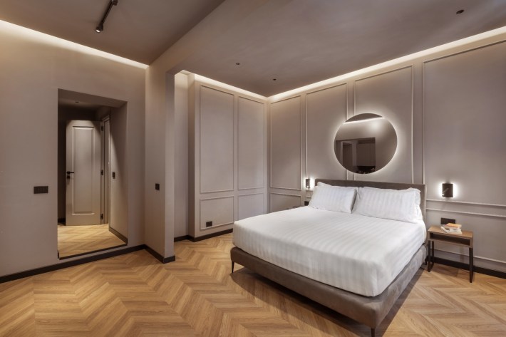 Designed for a restful stay, the sophisticated bedrooms showcase sleek Italian style, warm lighting, and minimalist elegance.