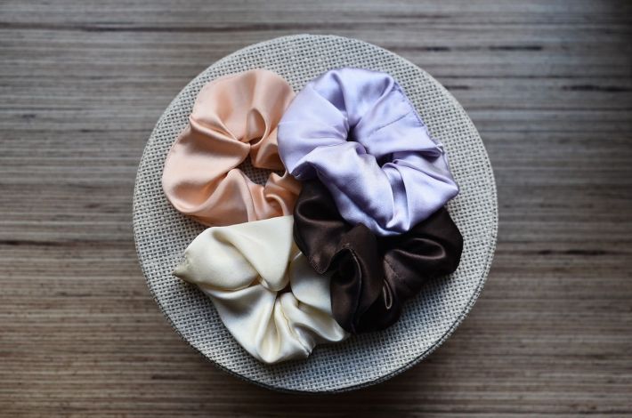 stash of chic silk om a basket on a wooden table