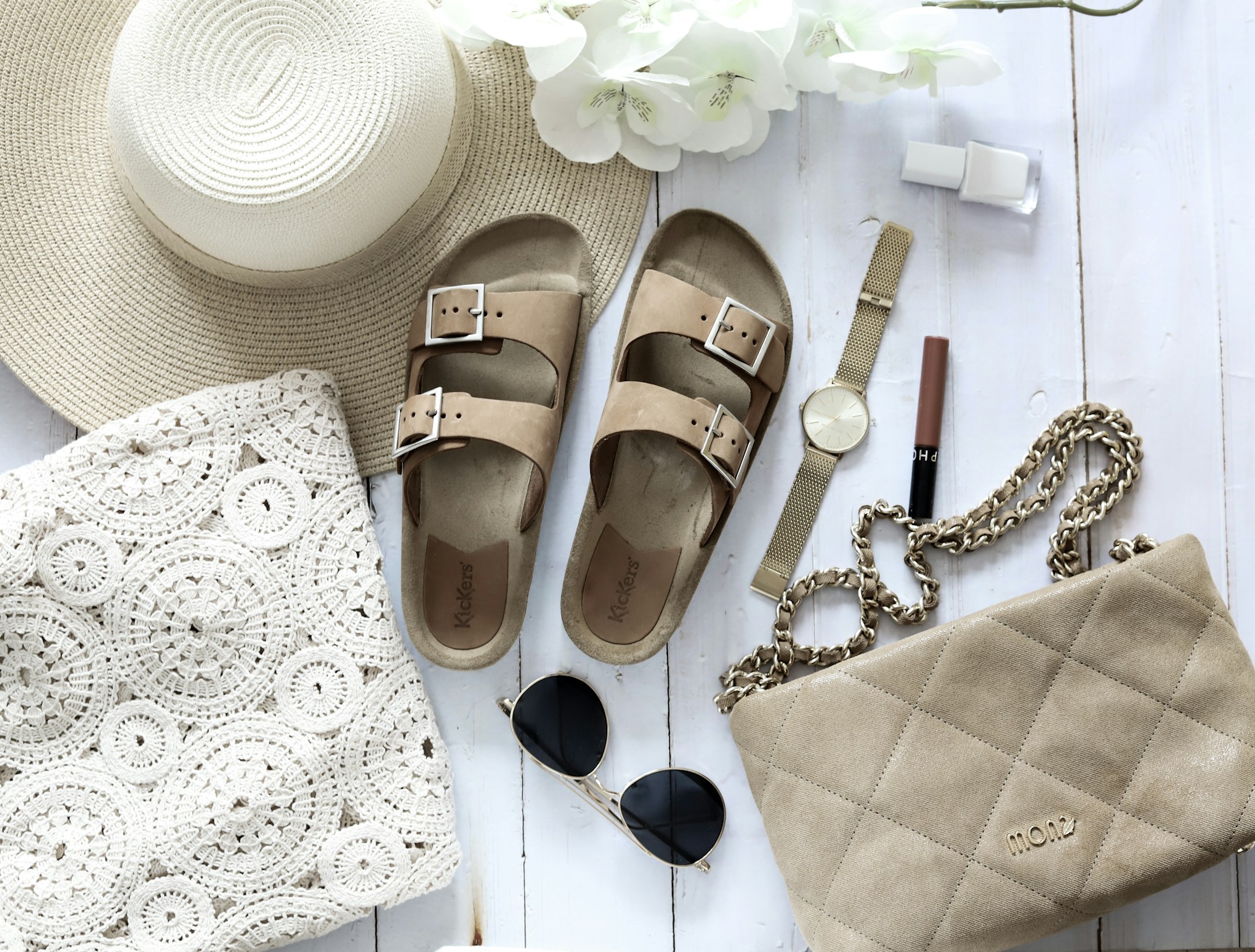 Sandals, sunglasses and jewelry to pack for a trip to Italy