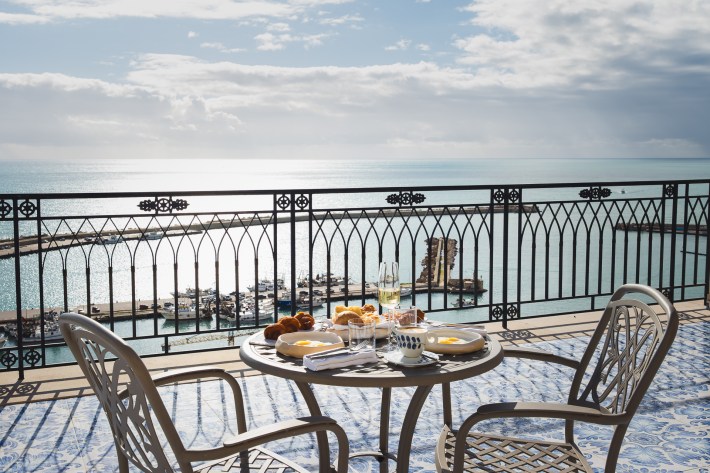 Exterior terrace of Vela restaurant in Sciacca Sicily overlooking the Mediterranean.