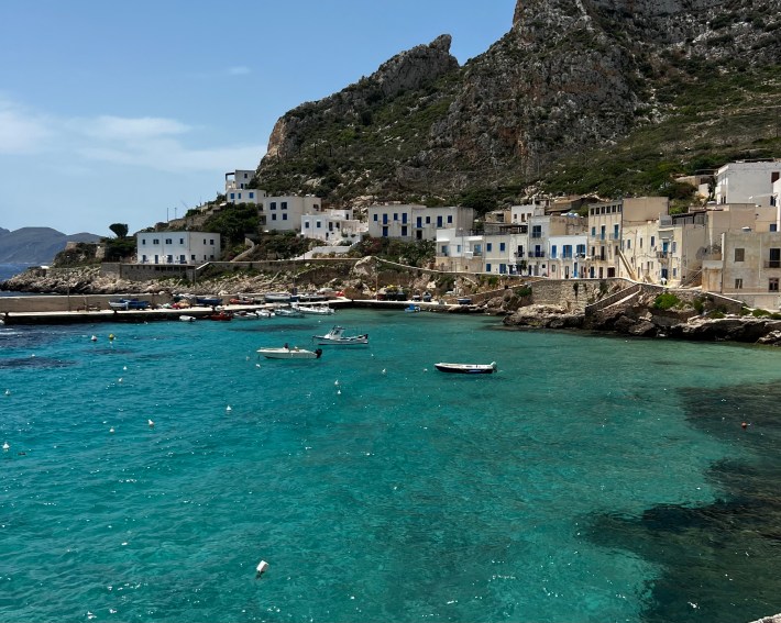Rocky shoreline and turquoise water in the Aegadian Islands, Sicily.