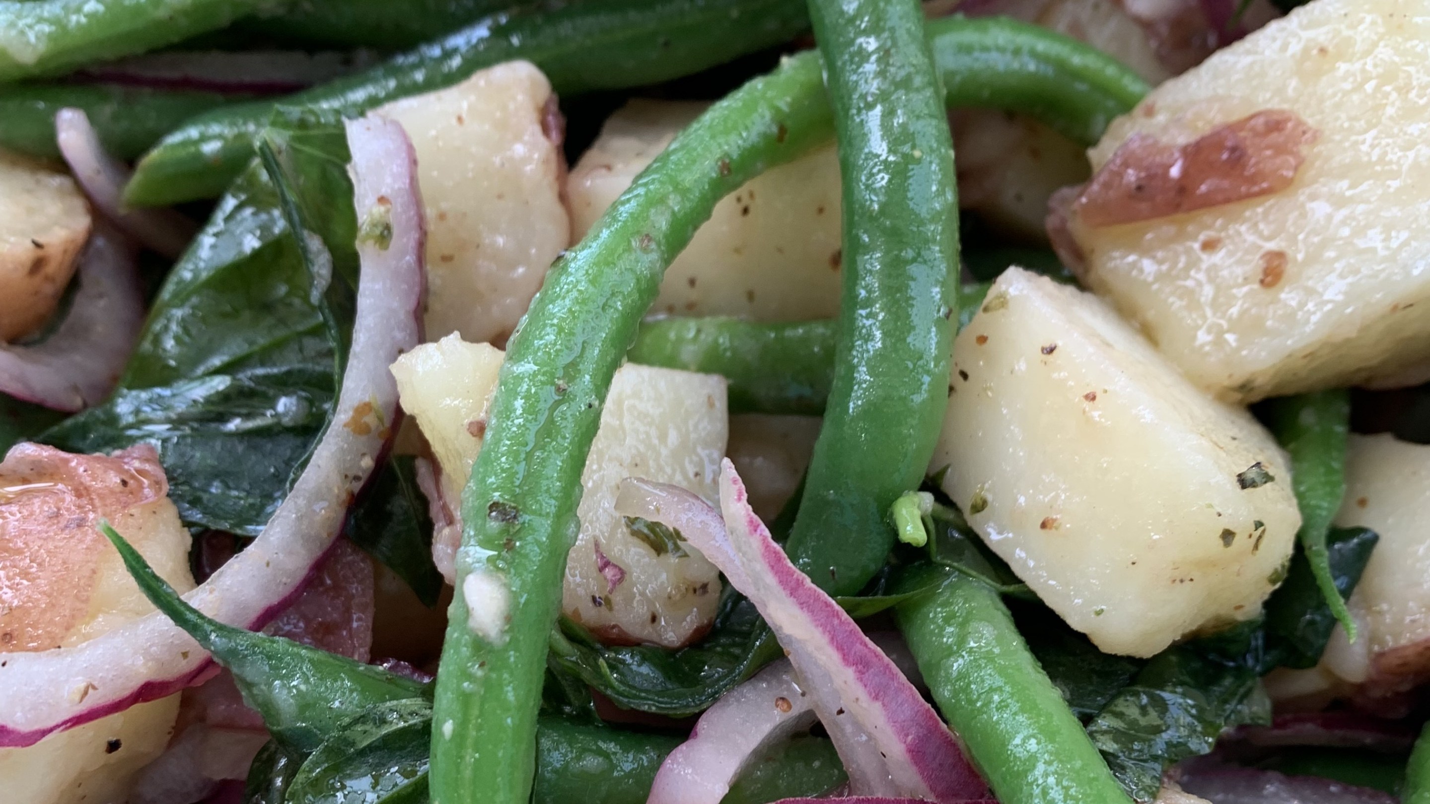 Fresh potatoes, crisp string beans, basil, and red onion come together in this classic Italian summer salad