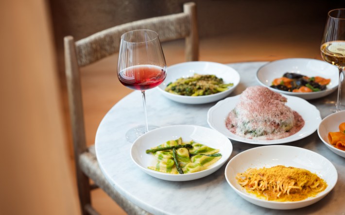 Assortment of handmade pasta dishes and wine served at Massara in New York City.