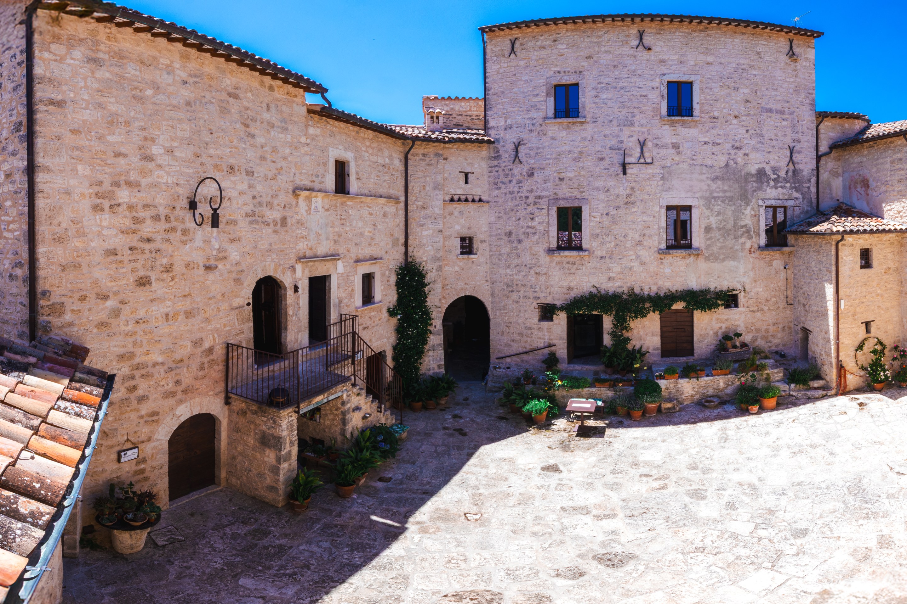 Historic stone courtyard at Castello di Luco in Le Marche, Italy.