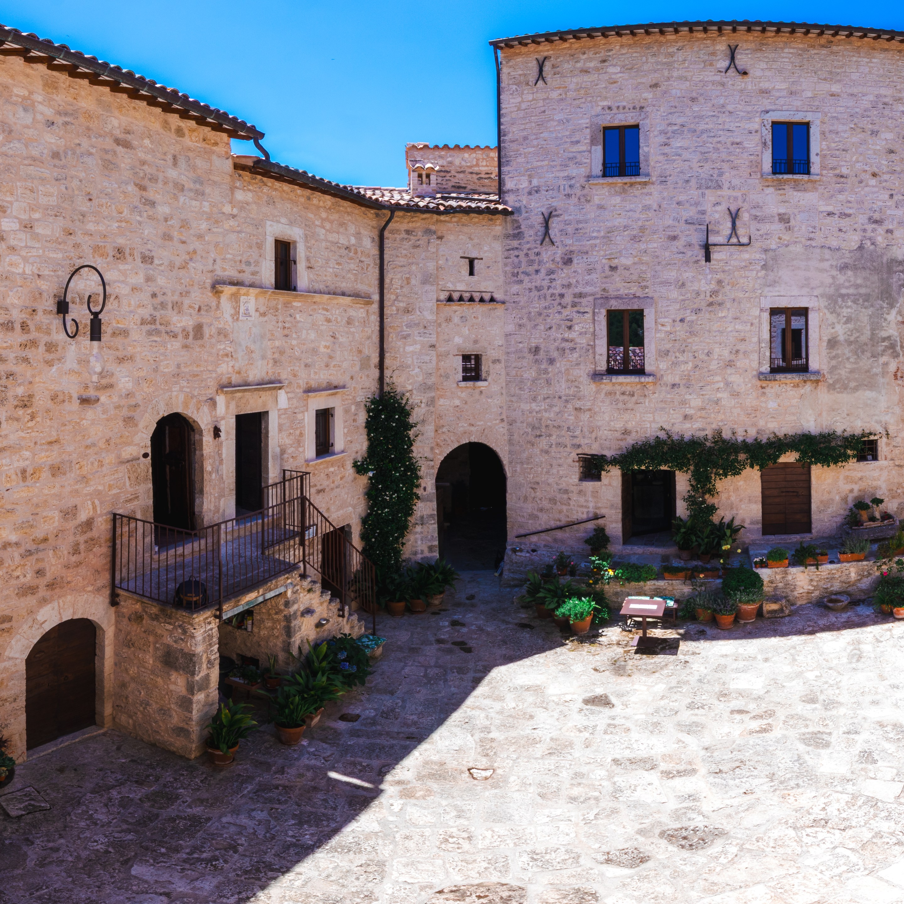 Historic stone courtyard at Castello di Luco in Le Marche, Italy.