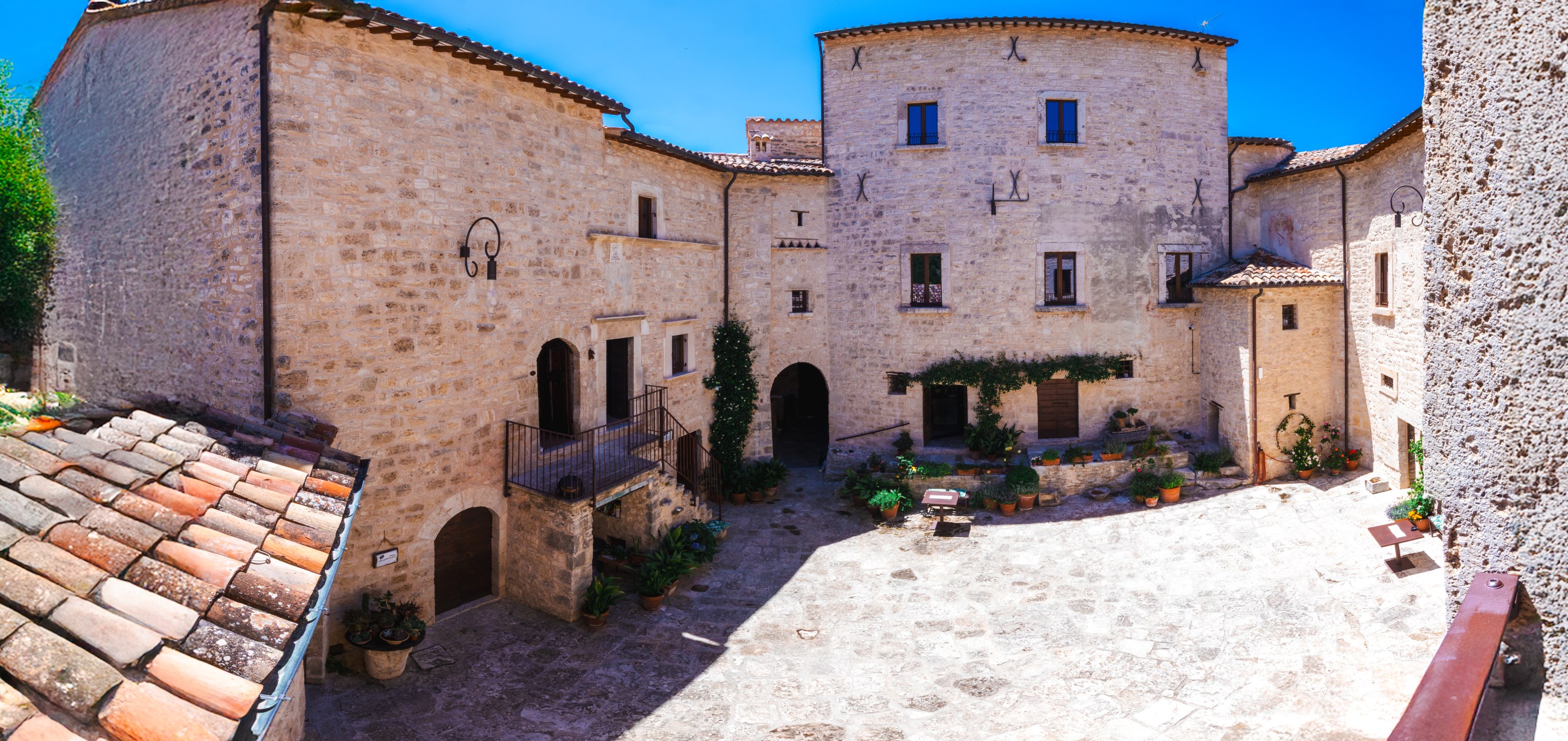 Historic stone courtyard at Castello di Luco in Le Marche, Italy.