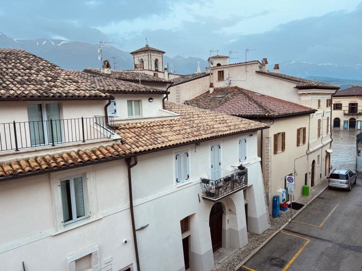 View over the rooftops of Norcia with the Sibillini Mountains in the distance.