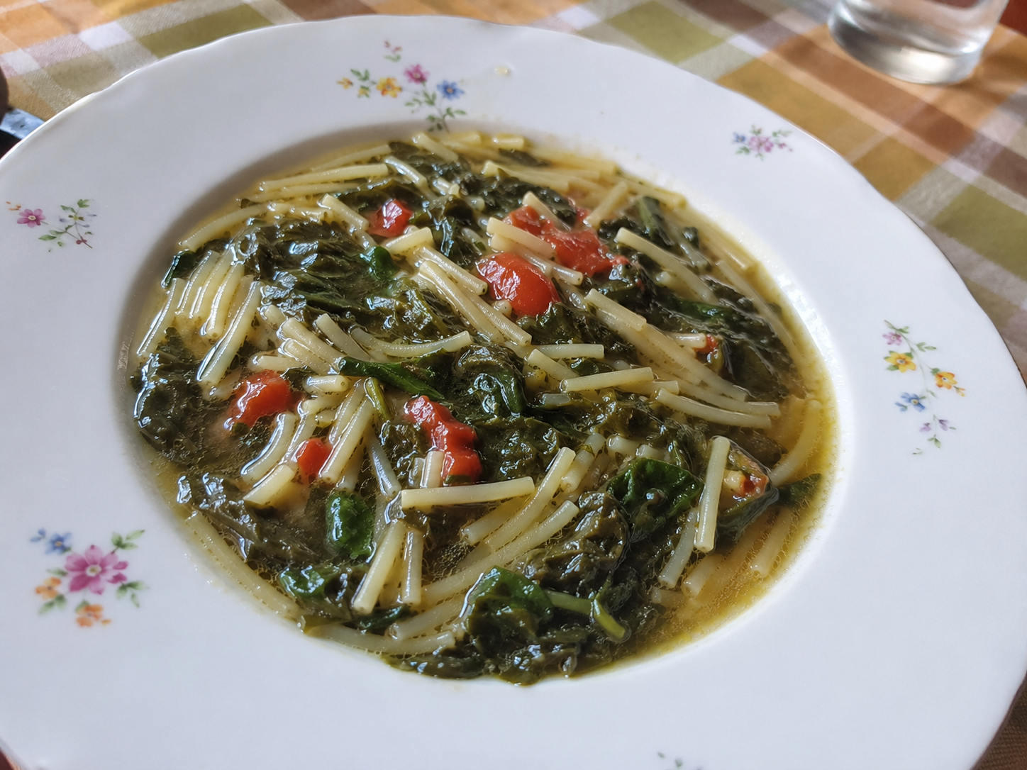 A traditional bowl of Sicilian tenerumi soup with pasta.