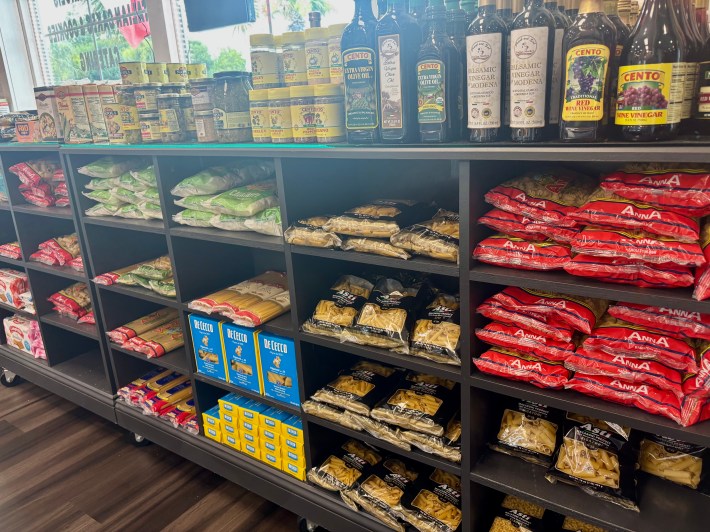 Shelves stocked with imported Italian pasta, olive oil and pantry items at Sarabella's.