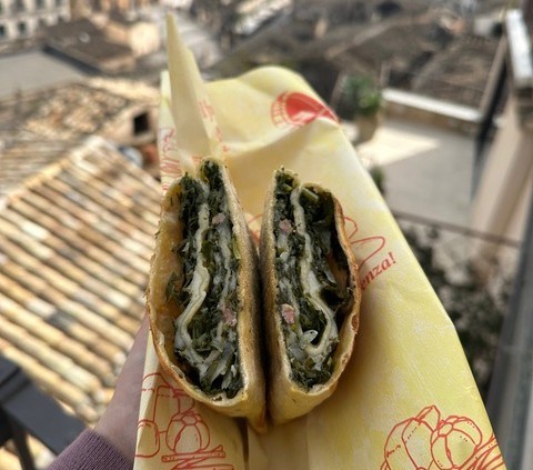 A baked specialty filled with greens in Sicily.
