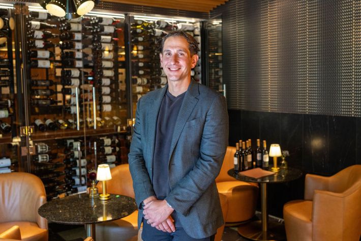 Pete Murdaca of Jimmy's in Lodi standing in front of wine bottles in the bar lounge