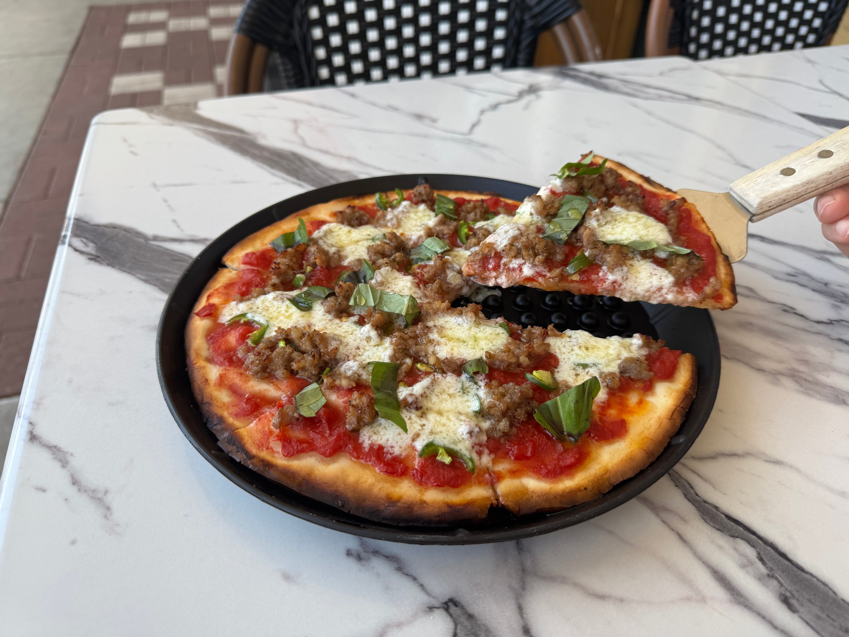 Gluten-free pizza topped with sausage, basil and cheese at Baldinucci Pizza Romana in Austin.