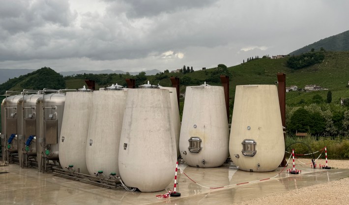 Wine fermentation tanks at Cartizze PDC surrounded by green hills in the Veneto