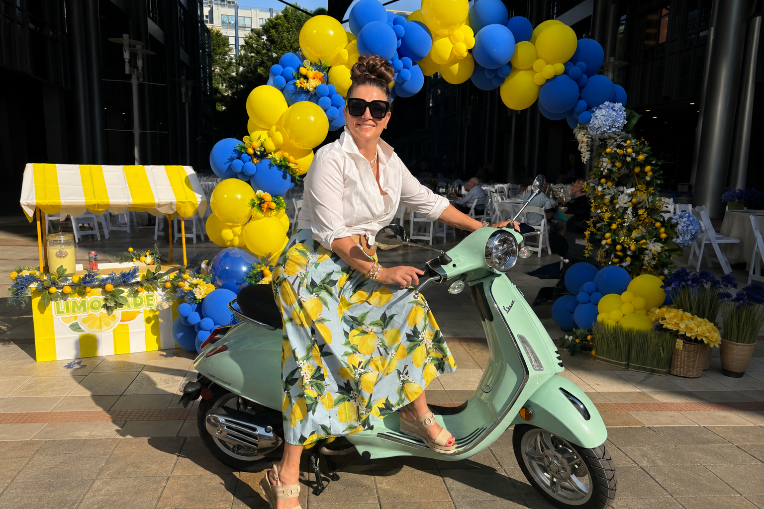 Mandi Casey is on a vesoa in a skirt with lemons
