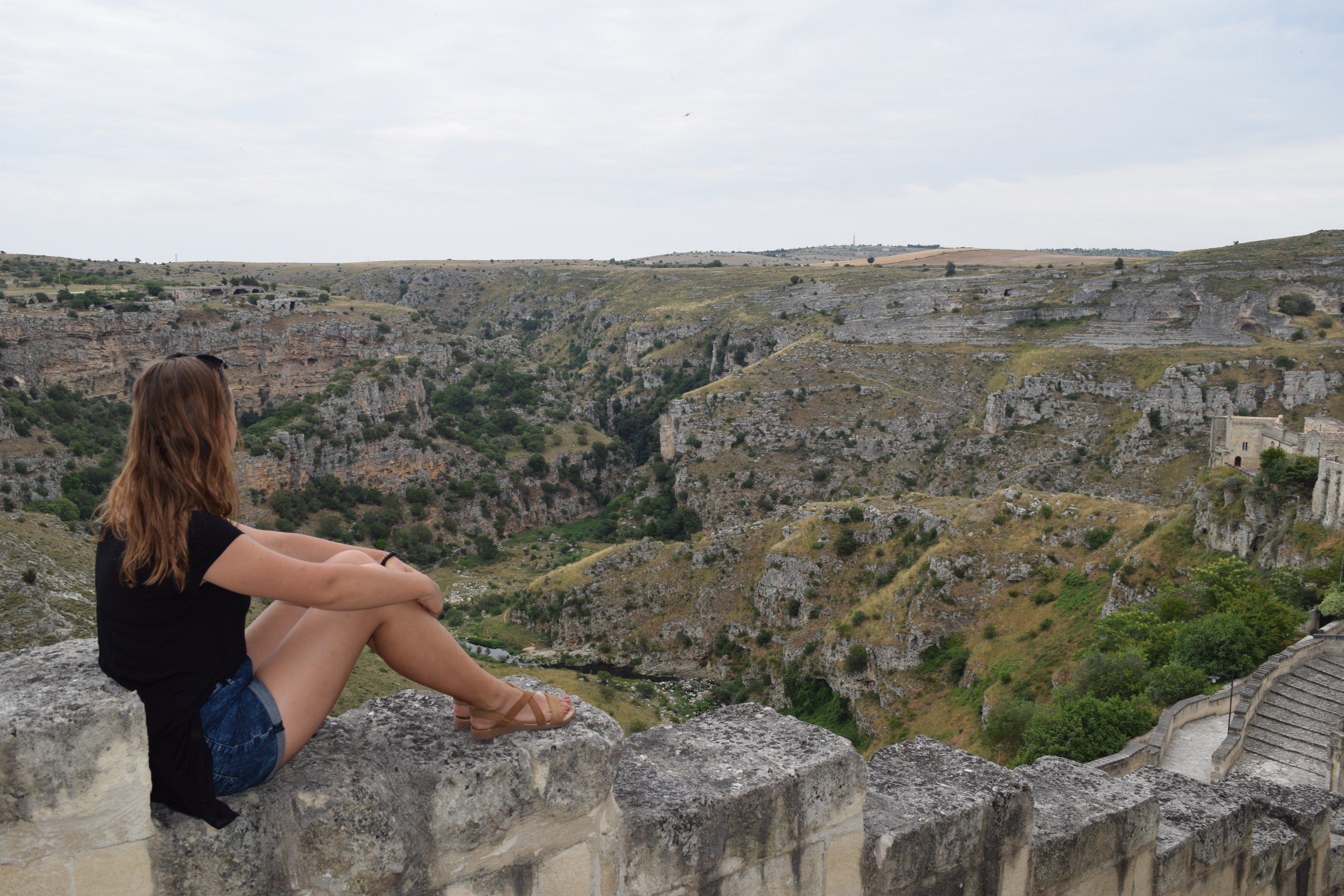 The author Sandra Ulewicz overlooking the rocky ravine and landscape surrounding Matera, Italy.