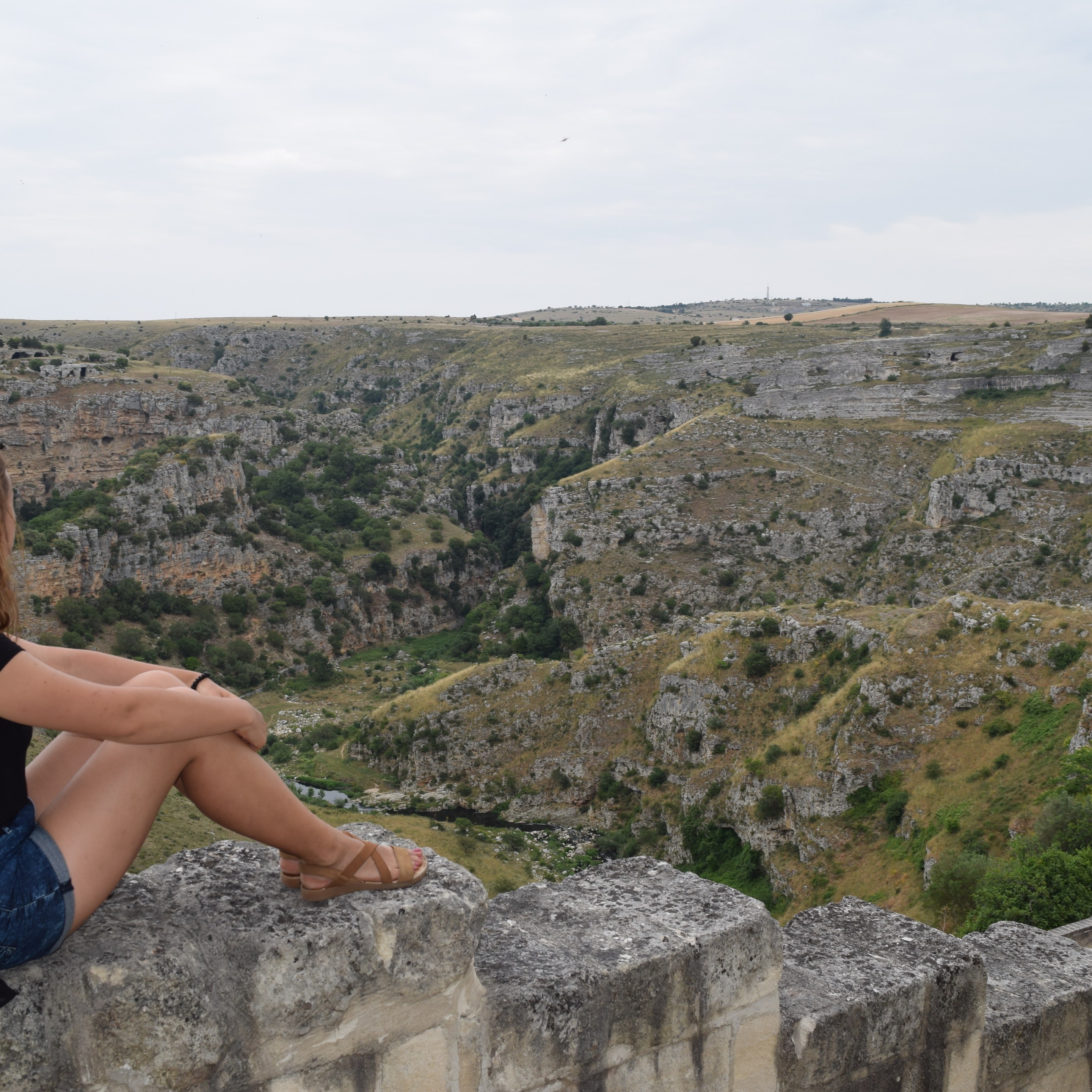 The author Sandra Ulewicz overlooking the rocky ravine and landscape surrounding Matera, Italy.