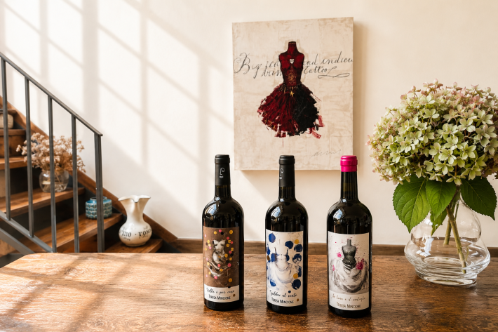 Teresa’s wine bottles with the painting by Luca Bellandi which inspired the labels. Photo credit: Jessica Holloway