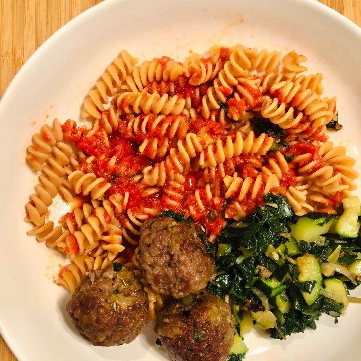 Rotini with tomato sauce, meatballs and vegetables.