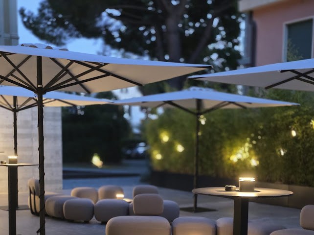 Outdoor terrace with umbrellas and lounge seating at Capitolo Riviera