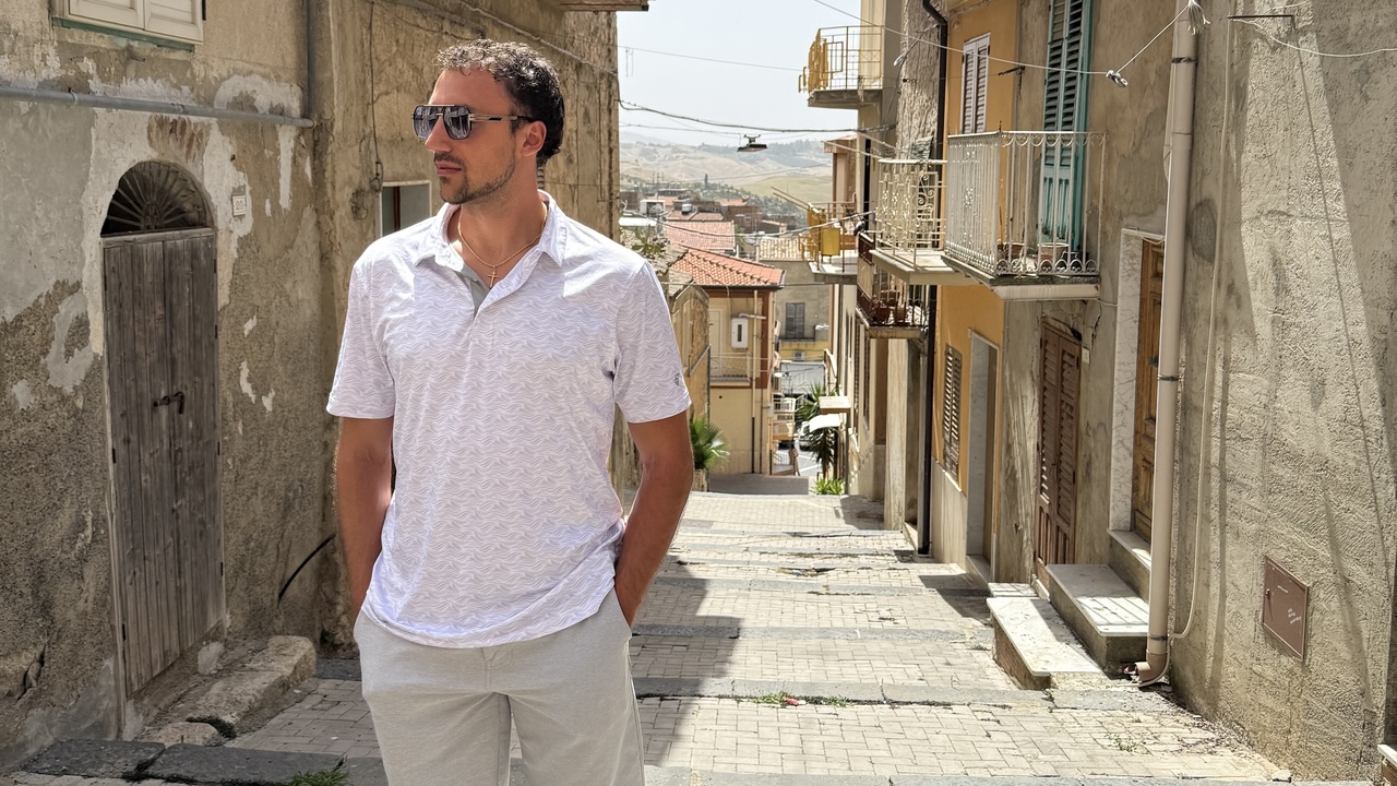 Anthony Castelvecchi walking through a historic street in Sicily.