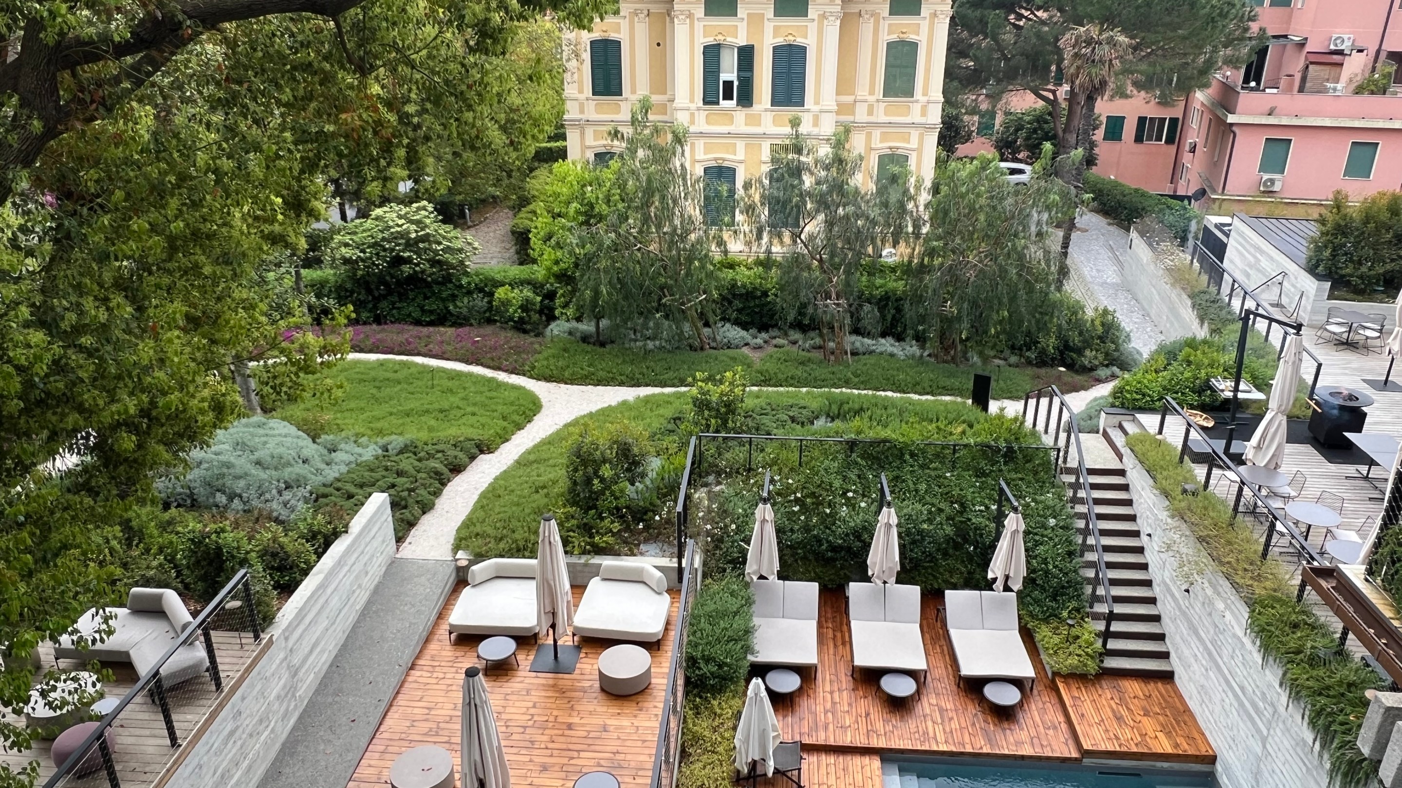 View of Capitolo Riviera’s pool, gardens and neighboring historic villa