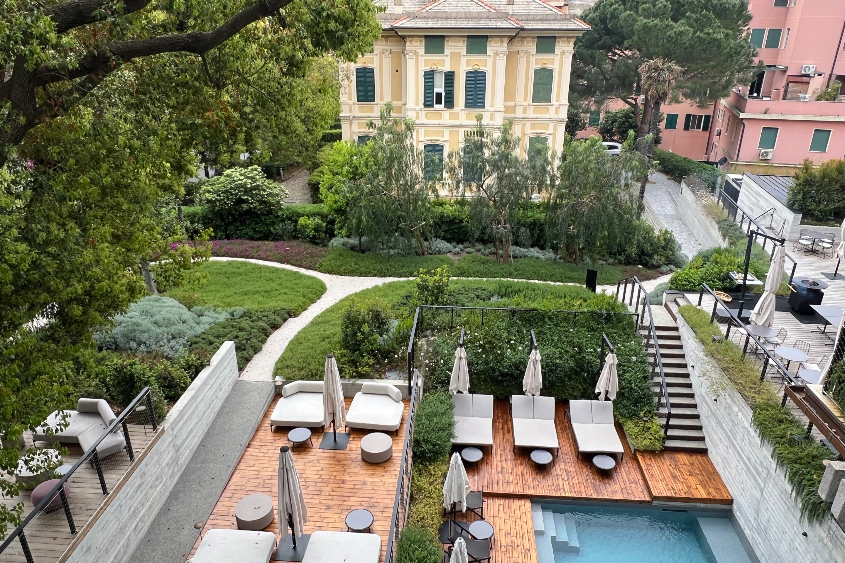 View of Capitolo Riviera’s pool, gardens and neighboring historic villa