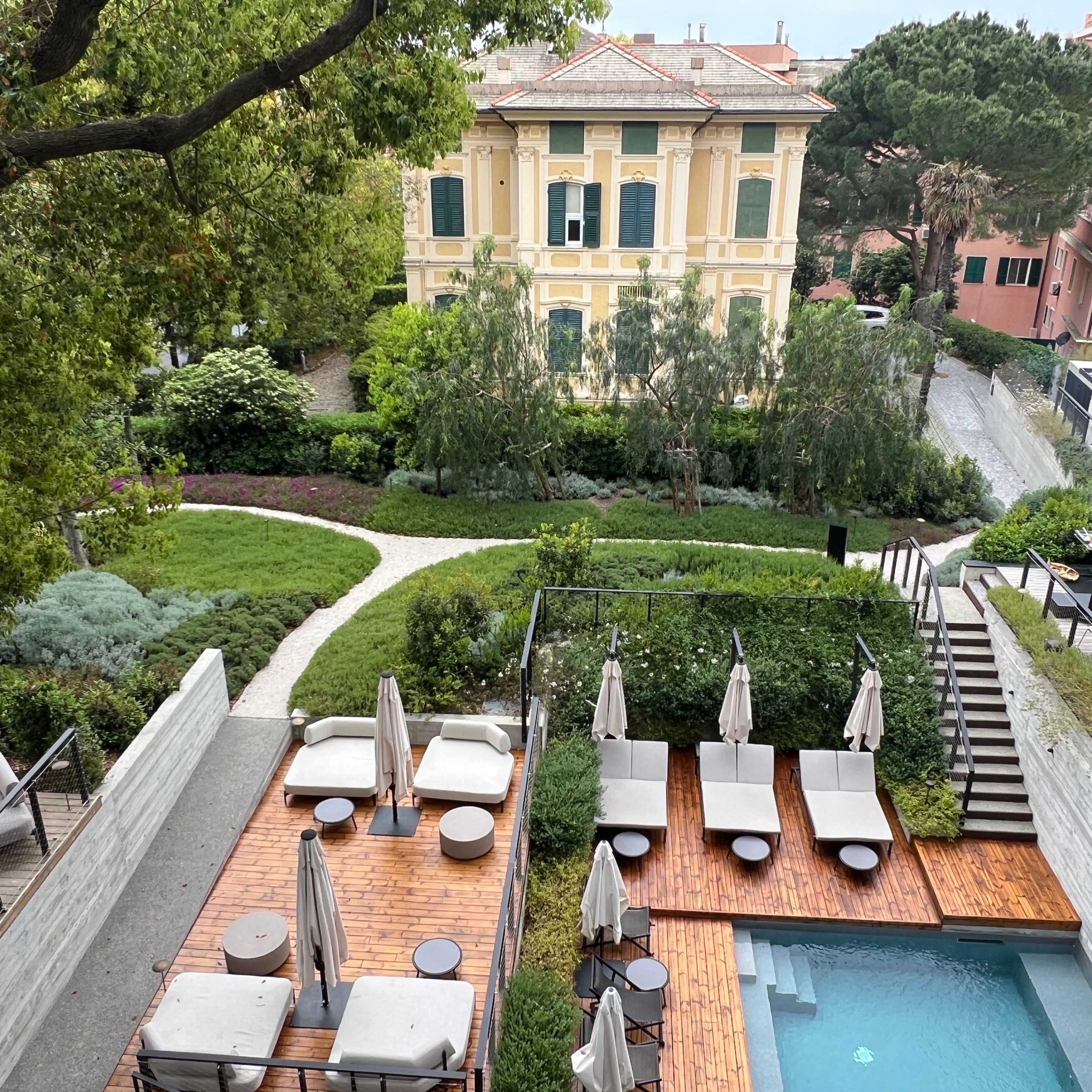 View of Capitolo Riviera’s pool, gardens and neighboring historic villa