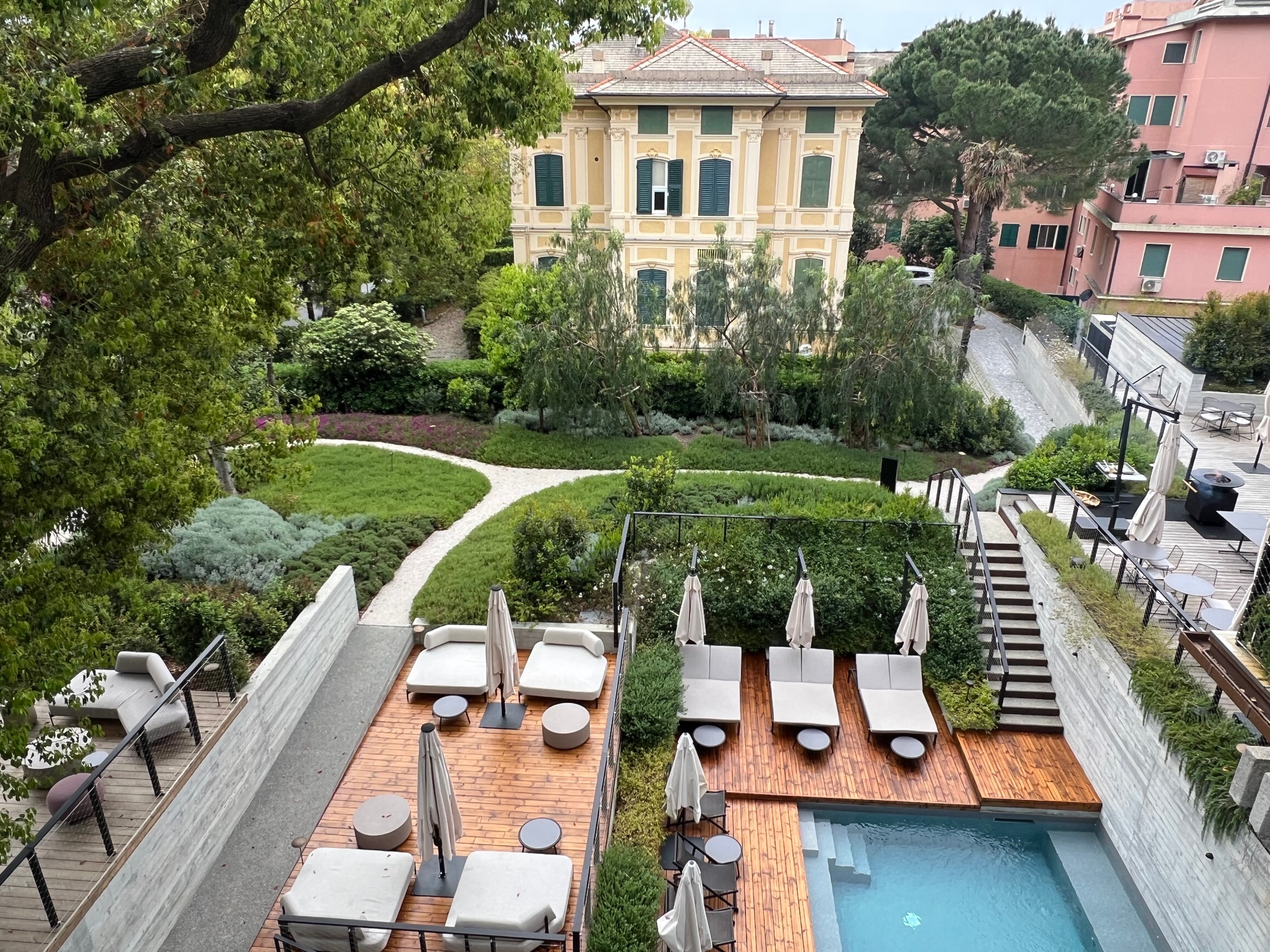 View of Capitolo Riviera’s pool, gardens and neighboring historic villa