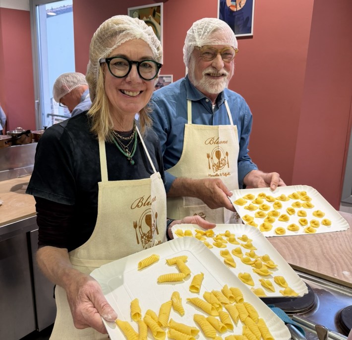 Travelers display handmade pasta during a pasta class in Emilia-Romagna.