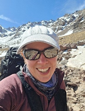 Clare Marston bio image hiking in the snow