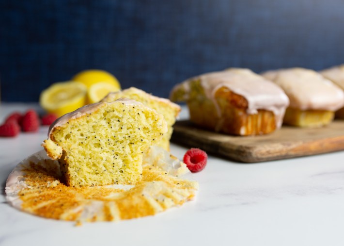 Gluten-free lemon poppy seed muffins topped with raspberry glaze.