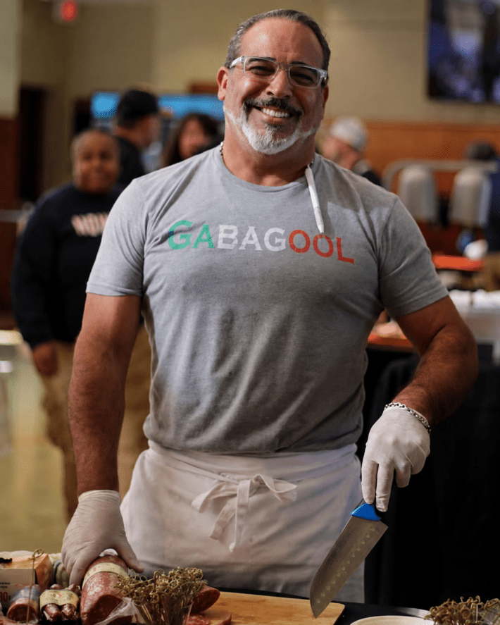Giacomo Santomauro prepares samples of Italian meats.