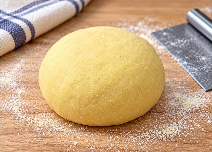 Eggless pasta dough on a floured wooden work surface
