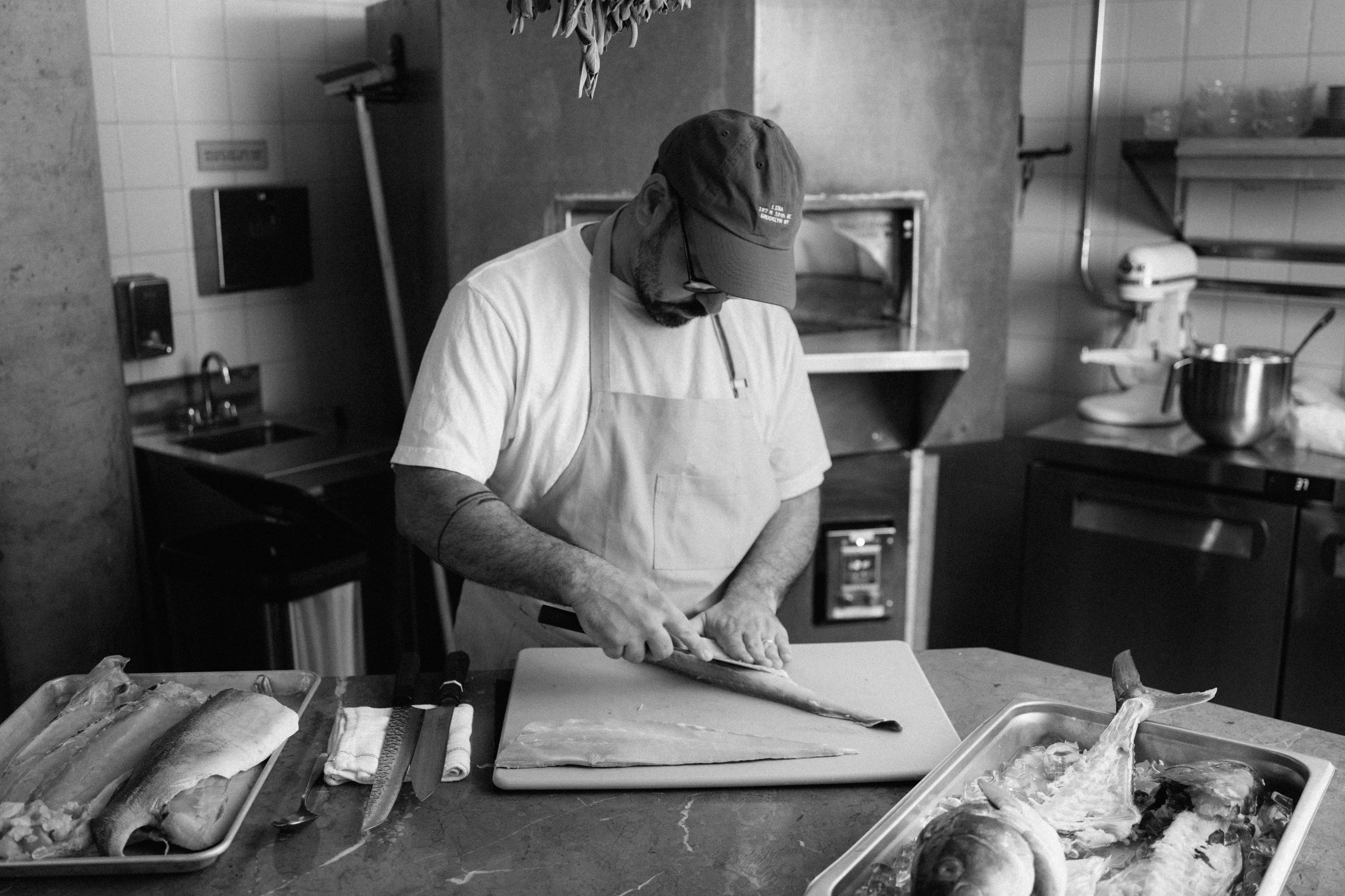 Chef Maayan Glass preparing a whole fish at LIBA