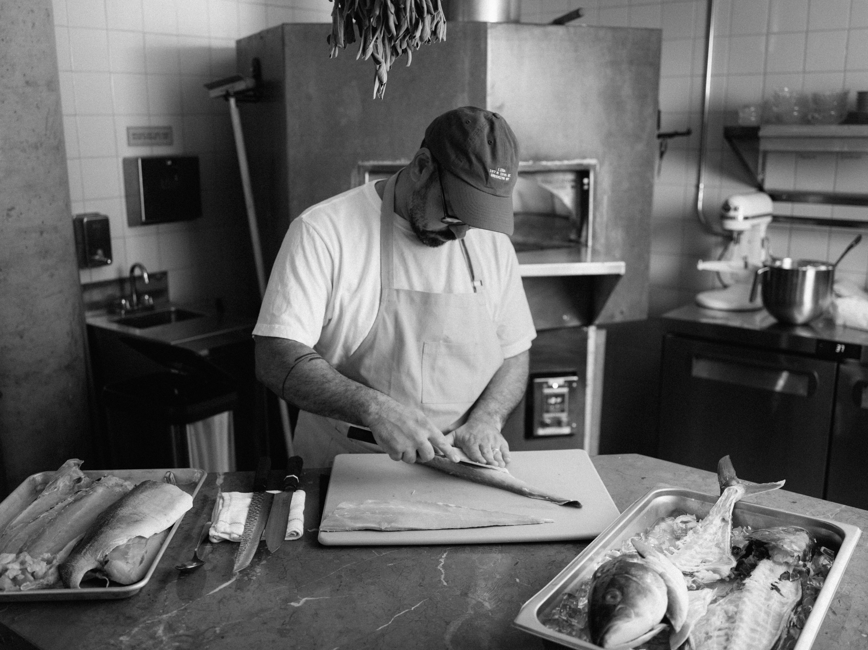 Chef Maayan Glass preparing a whole fish at LIBA