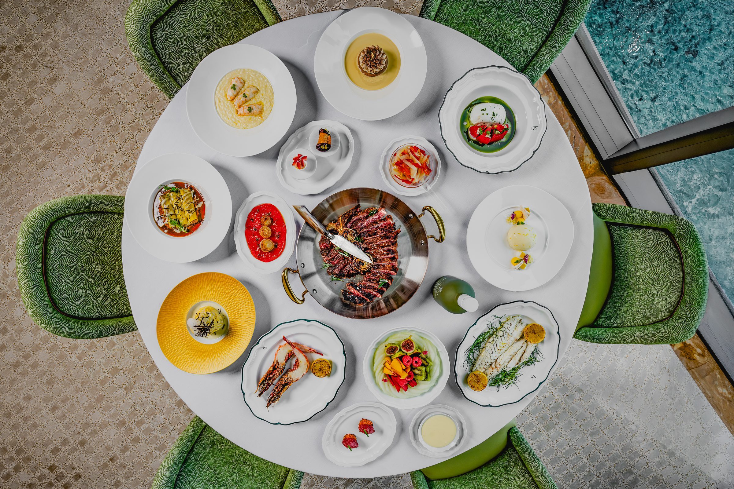 Italian dishes, seafood, steak and desserts arranged on a table at La Sponda in Miami.