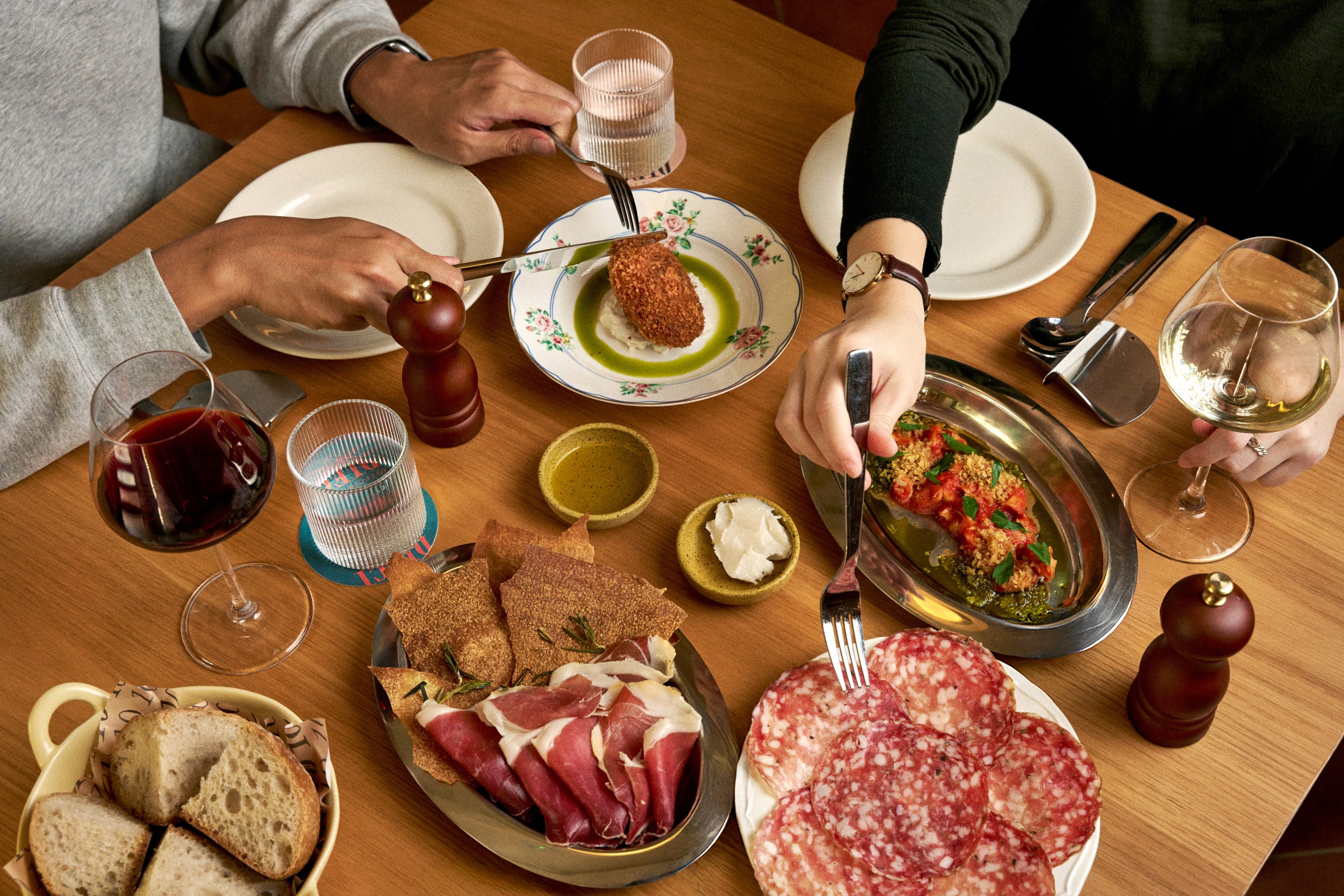 Rustic bread “Amo ago” Bakery, Oxtail suppli, Colli etruschi olive oil, Lardo battuto, Local sea snail in spicy tomato sauce, Finocchiona salami, Giancarlo Tanara 24-month prosciutto di Parma at DIECI in Hong Kong. Photo: DIECI, Paolo Olivieri