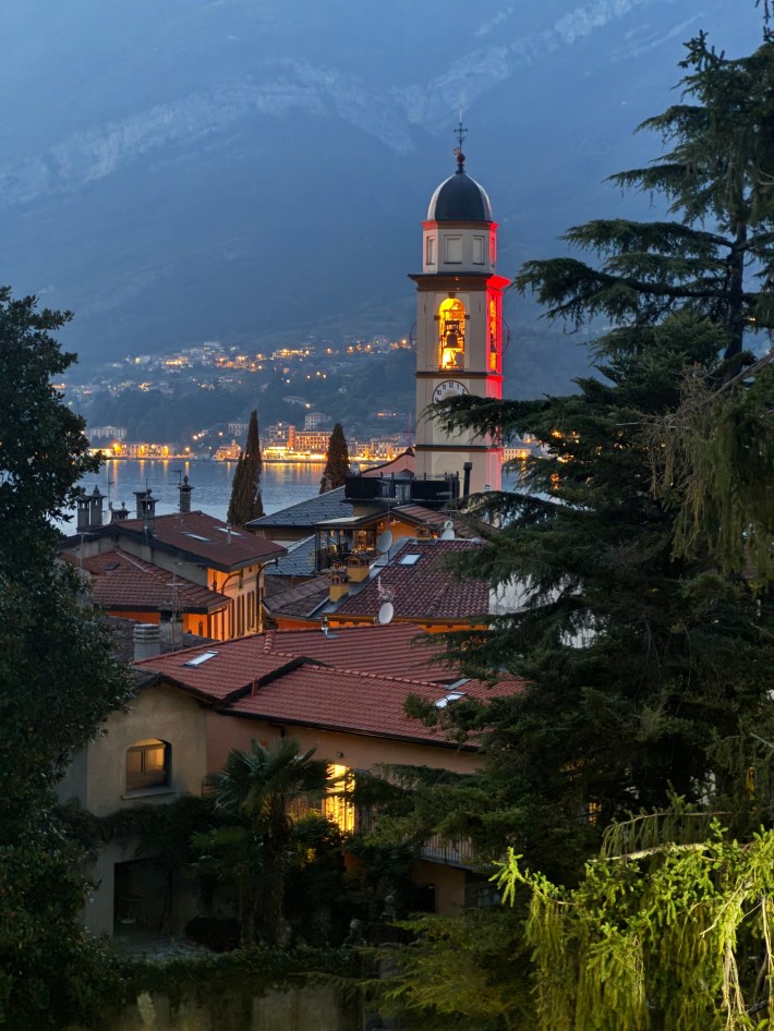 Bell tower of the Church of San Giovanni above Lake Como at dusk.
