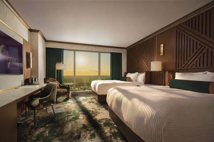 Guest room with two beds and large windows at The Crescent at Turning Stone Resort Casino