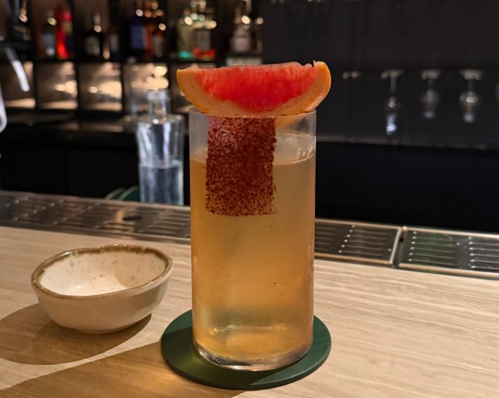 Spice Route cocktail garnished with grapefruit at YEZI Bar