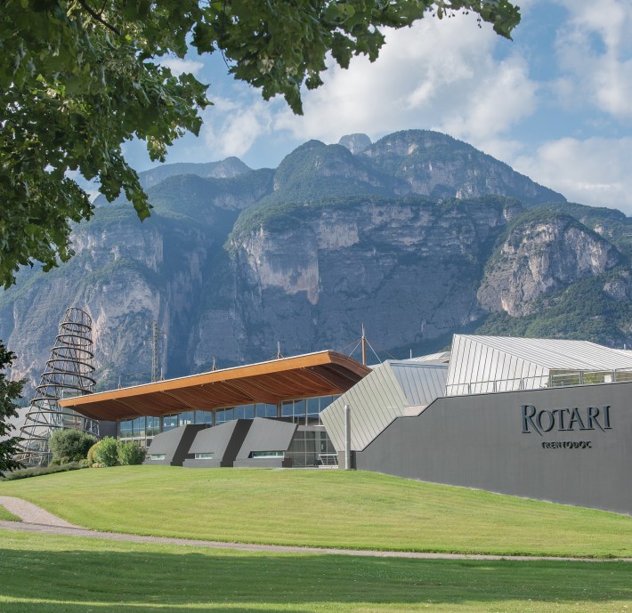 Rotari Trentodoc winery beneath steep mountains in Trentino, Italy.