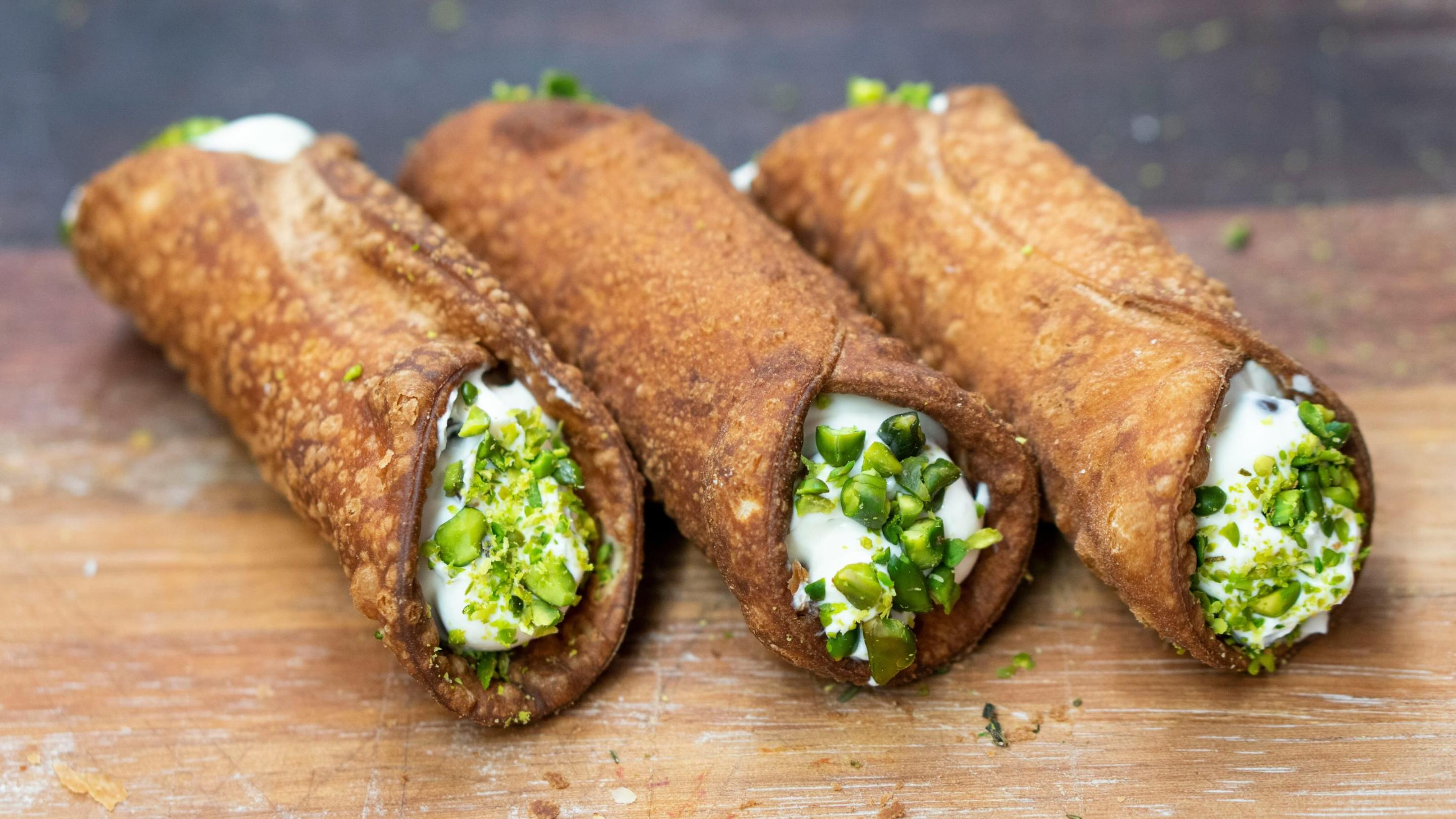 Cannoli filled with sweet ricotta. Photo by Adrian Balasoiu/Unsplash.
