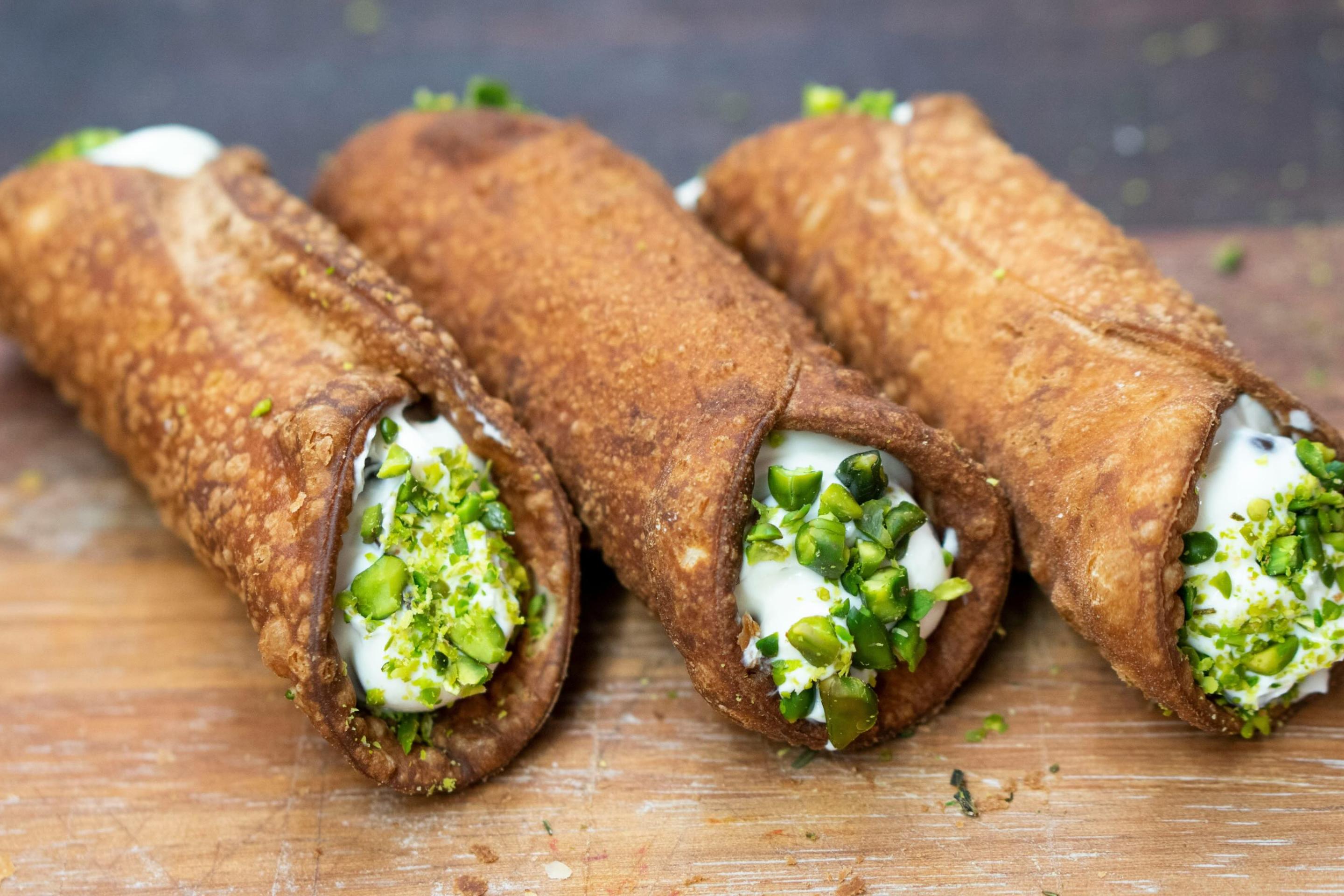 Cannoli filled with sweet ricotta. Photo by Adrian Balasoiu/Unsplash.