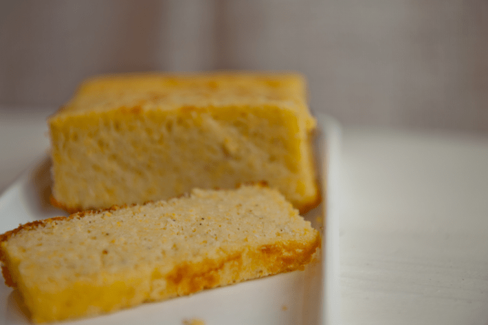 Slices of cooked polenta on a white plate.
