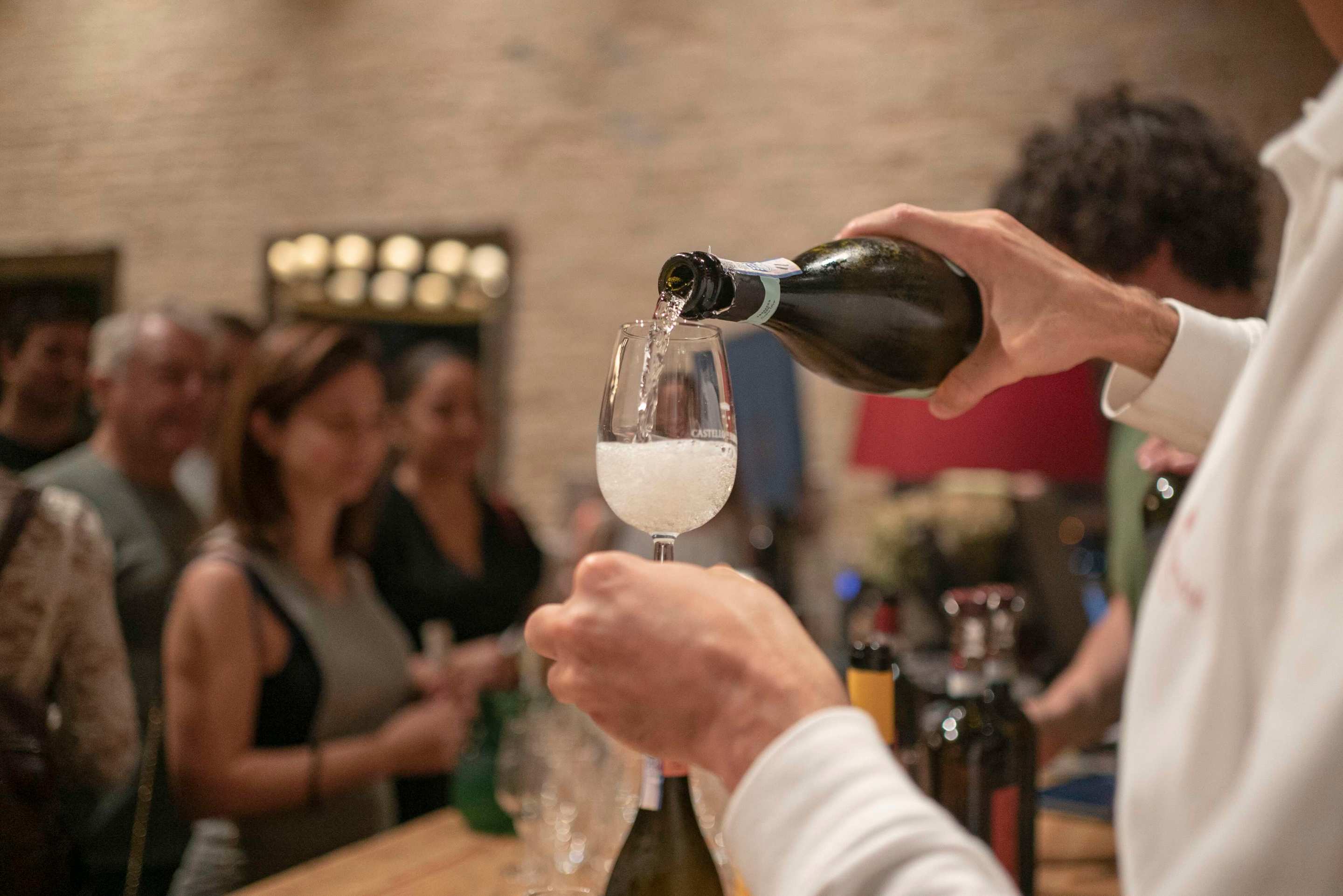 person pouring prosecco